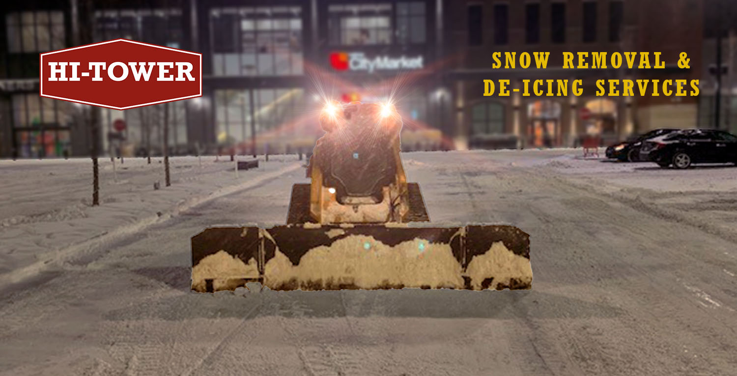 Hi-Tower snow removal service clearing a commercial parking lot with de-icing solutions.