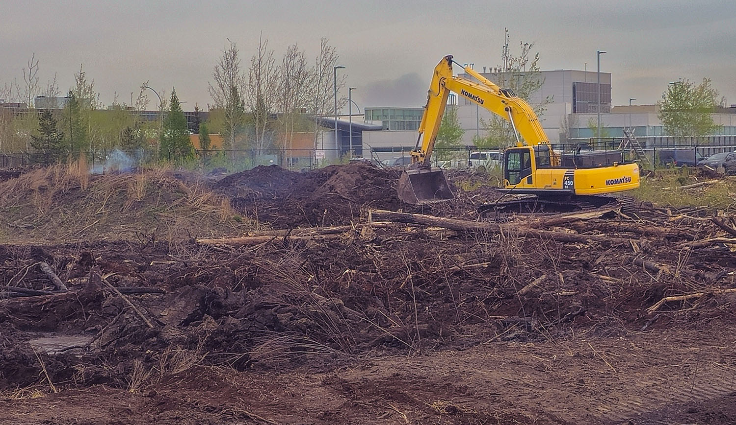 Hi-Tower excavator working in the south section of the Poundmaker site during peat fire suppression and reclamation operations in May 2025.